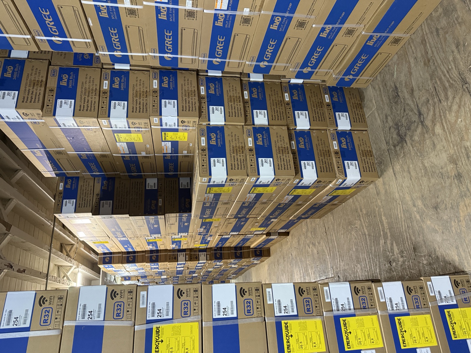 Pallets of Gree split-system air conditioner boxes stacked floor to ceiling in the Kings AC Supply wholesale warehouse