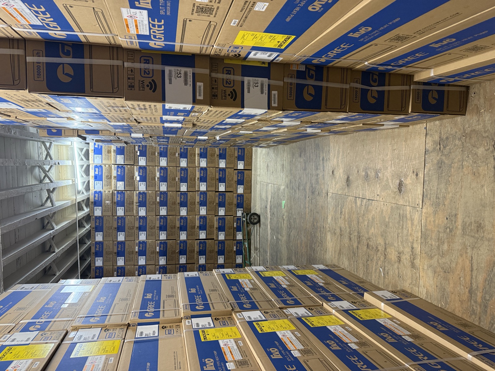 Warehouse aisle lined with Gree and Livo air conditioner boxes at Kings AC Supply Brooklyn