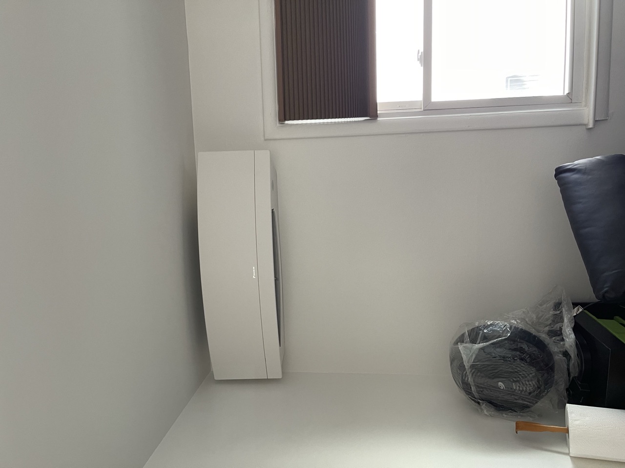 Daikin floor-mount tower air conditioner installed in the corner of a small Brooklyn room