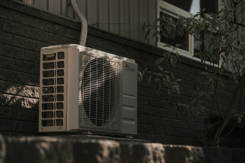 An outdoor heat pump unit installed beside a home