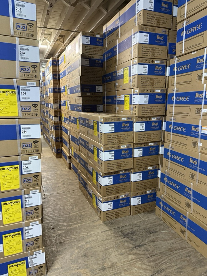 Pallets of Gree air conditioner boxes stacked in the Kings AC Supply warehouse aisle