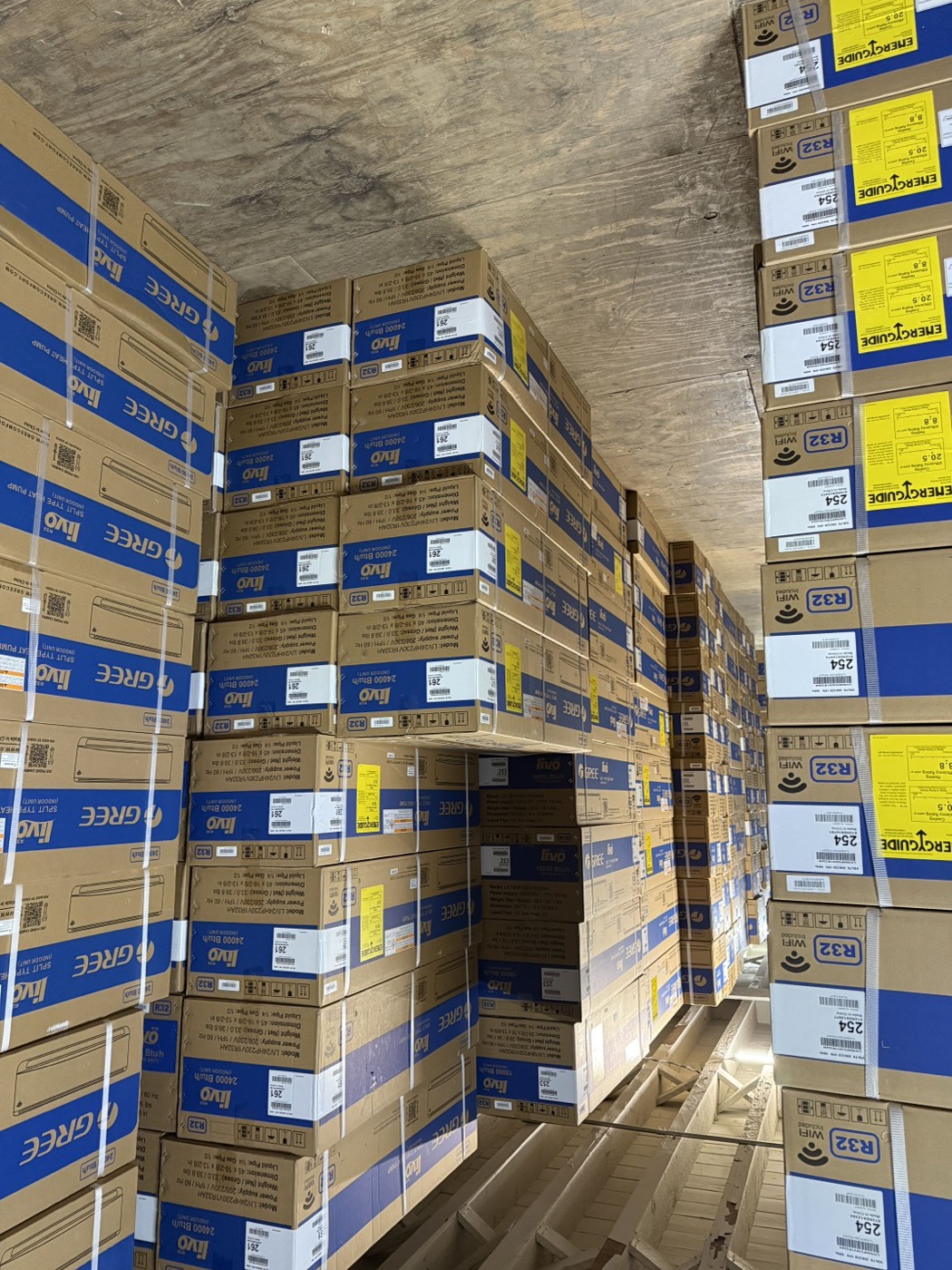 Stacks of Gree-branded air conditioning units in stock at the Kings AC Supply Brooklyn warehouse